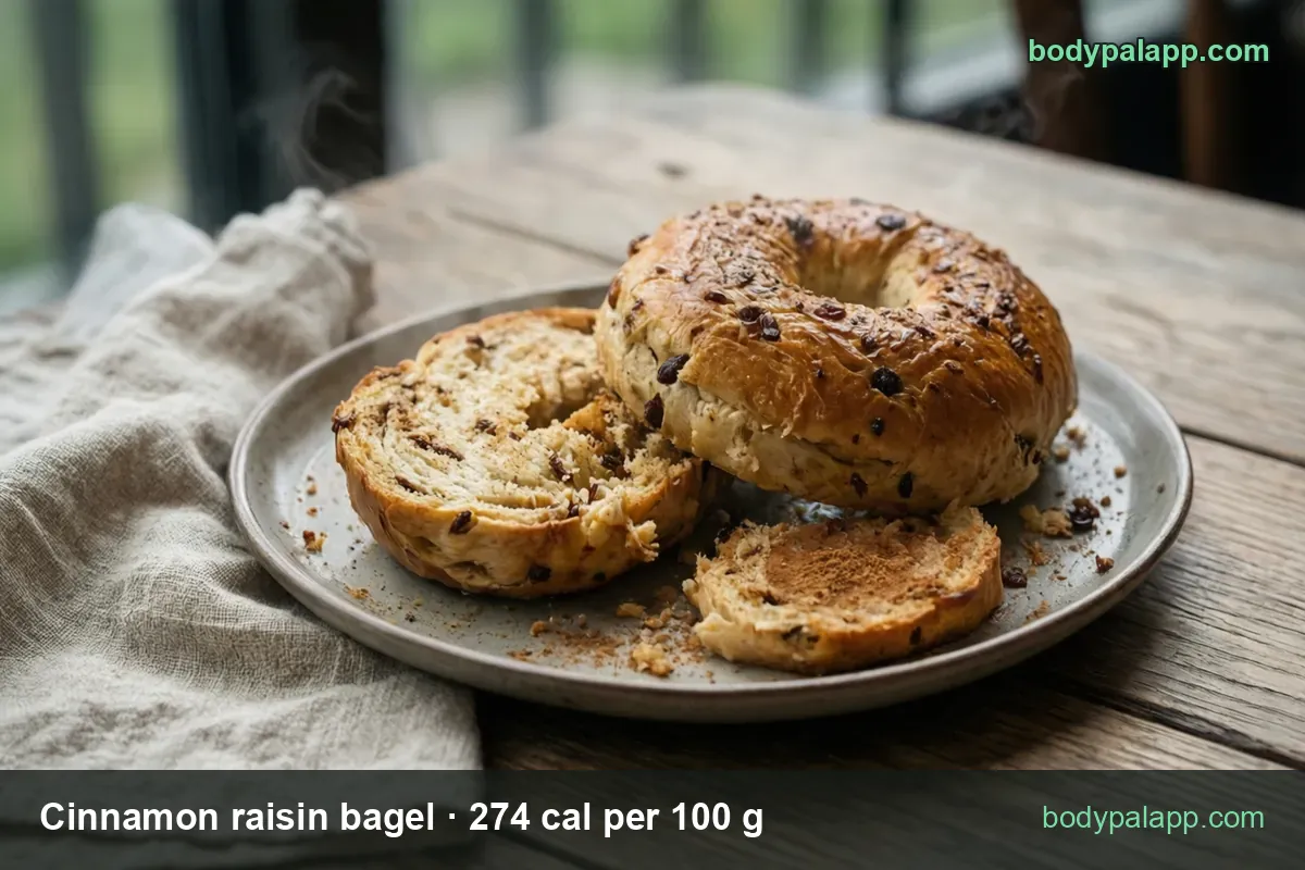 Whole cinnamon raisin bagel and two halves on a plate, raisins and cinnamon dusting; 1 medium bagel 105 g, 1 small bagel 69 g.