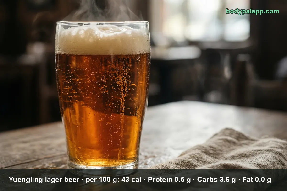One pint glass of amber lager with a thick foam head and rising haze, no bottle and no branding